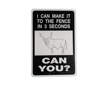 I Can Make It To The Fence Aluminum Sign on a wooden post with text and a Watusi Bull illustration, set against a rural landscape.