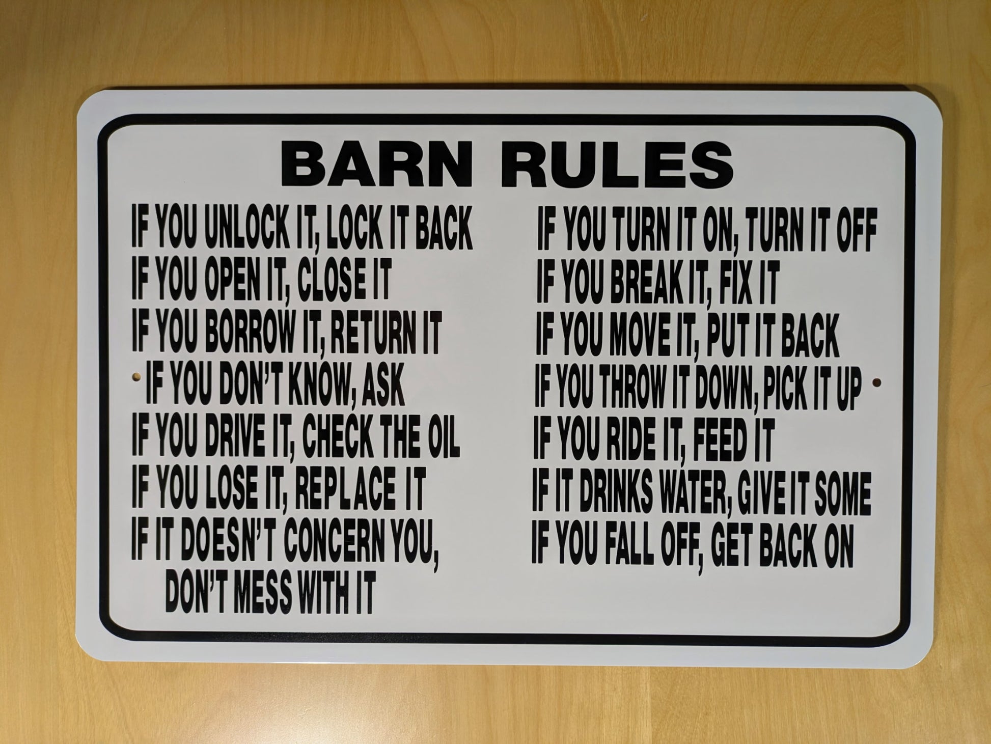 Barn rules sign on a wooden surface