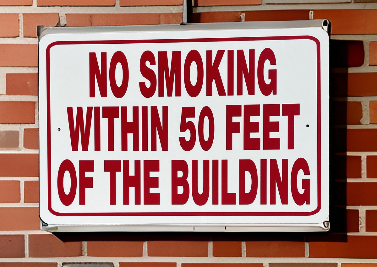 No smoking Aluminum sign on a brick wall